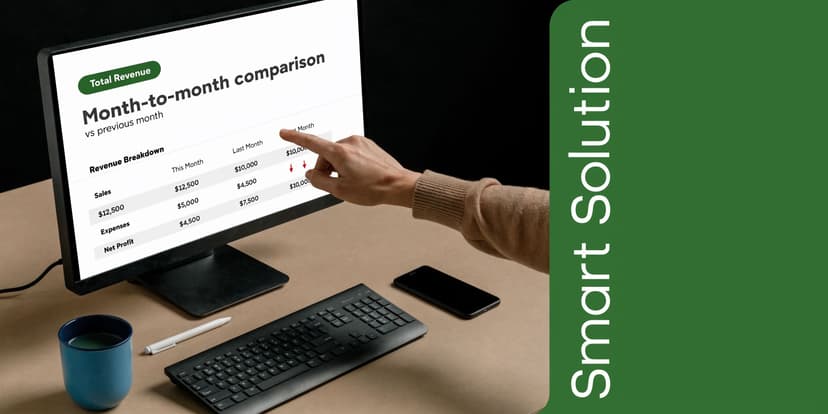 A person pointing at a financial chart on a computer monitor showing monthly revenue and expenses comparison.